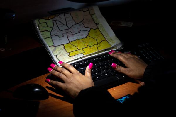 Griggs works at her desk at the call center last week. (Casey Sykes for The Atlanta Journal-Constitution)