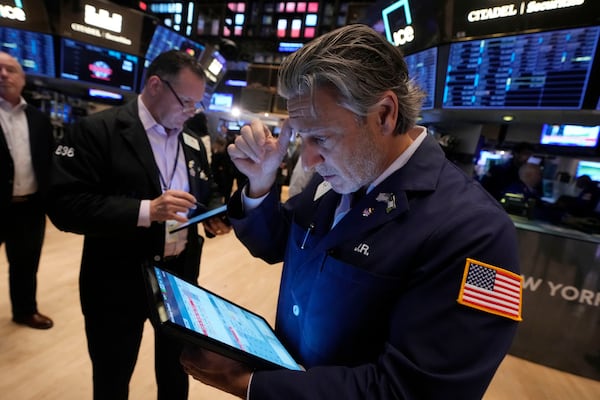 Trader John Romolo, right, works on the floor of the New York Stock Exchange, Wednesday, Nov. 6, 2024. (AP Photo/Richard Drew)