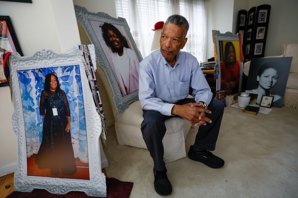 Joseph Larche poses in the living room of his house surrounded by his wife and daughter's portraits. Joseph experienced the death of two loved ones, first his wife Diane Larche passed away in January with pancreatic cancer, and two months later his daughter Stephanie died of a heart attack. (Miguel Martinez / AJC)