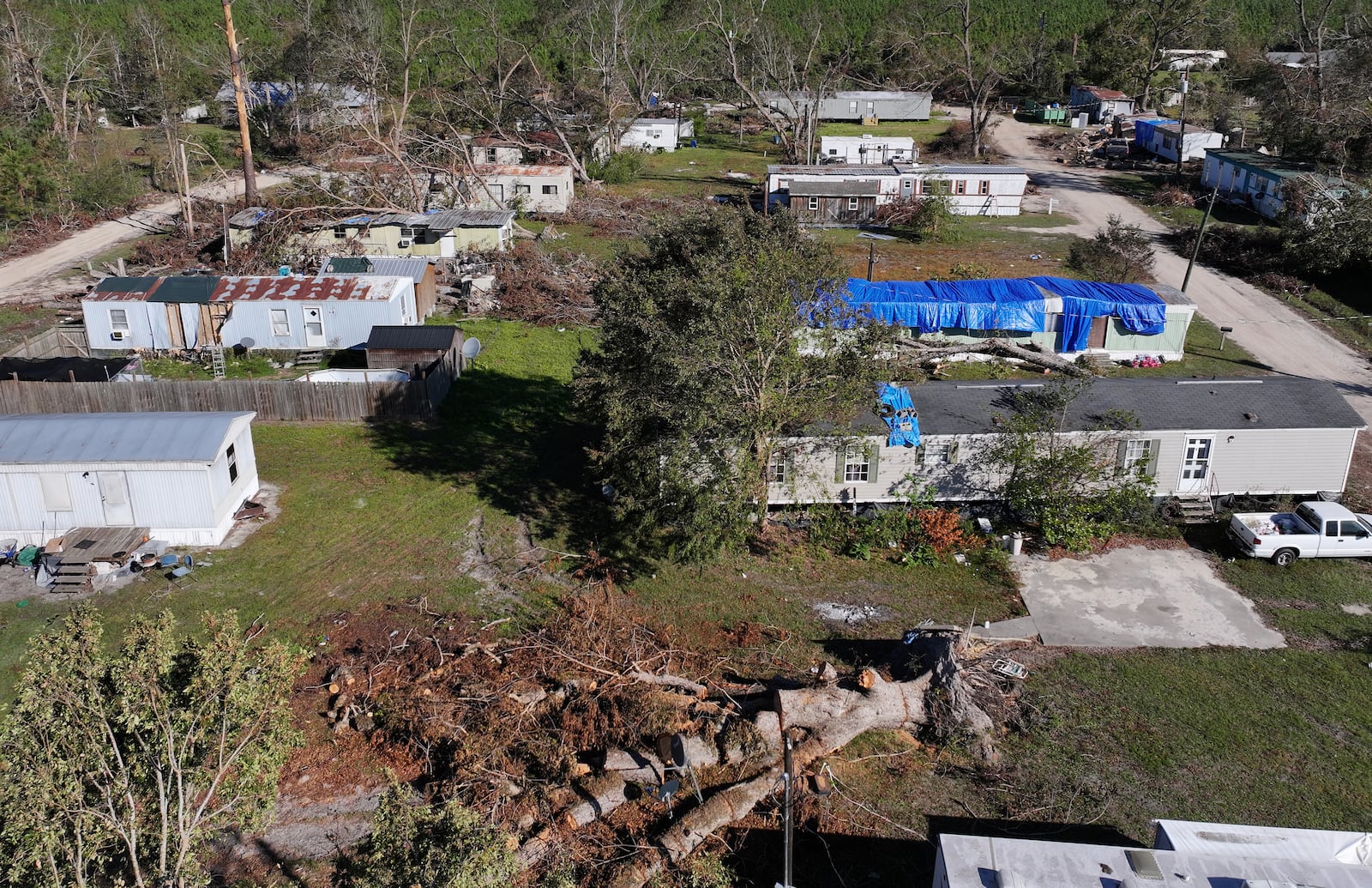 An aerial photo shows the Pecan Park mobile home community surrounded by debris in the aftermath of Hurricane Helene on Monday, Oct. 21, 2024, in Hazlehurst, Ga. (Hyosub Shin/AJC)