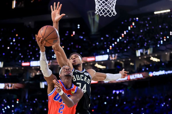 Oklahoma City Thunder guard Shai Gilgeous-Alexander (2) shoots against Milwaukee Bucks forward Giannis Antetokounmpo (34) during the first half of the championship game in the NBA Cup basketball tournament Tuesday, Dec. 17, 2024, in Las Vegas. (AP Photo/Ian Maule)