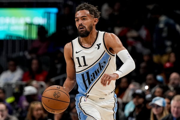 Atlanta Hawks guard Trae Young (11) moves the ball up court against the Dallas Mavericks during the first half of an NBA basketball game, Monday, Nov. 25, 2024, in Atlanta. (AP Photo/Mike Stewart)