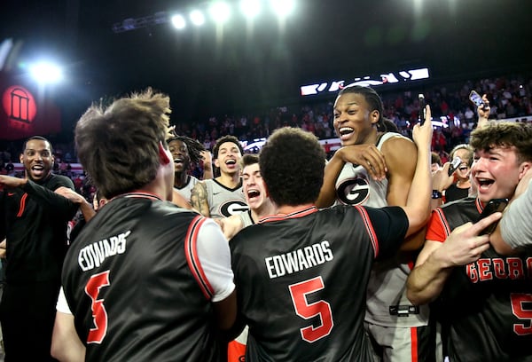 Georgia players and fans (wearing giveaway Anthony Edwards jerseys) celebrate the win over Florida.