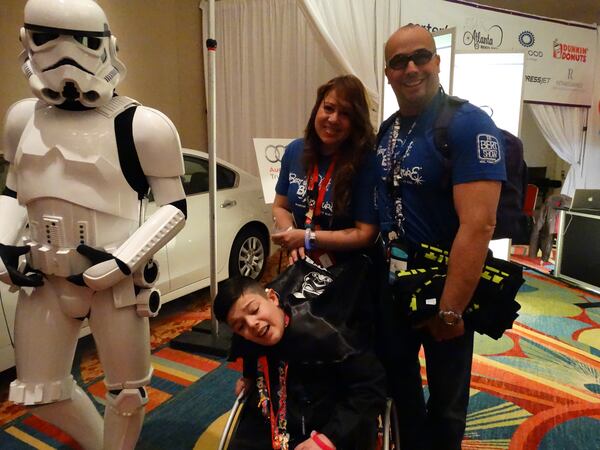 Raymond Grannell of Powder Springs (right) moved his family from Puerto Rico to treat his son Raynel, who got bacterial meningitis in 2014. He suddenly became ill, lost his hearing and fell into a coma. He is on a slow road to recovery. Raymond, now a Cobb County police officer, said he's just grateful his son survived an often fatal disease. CREDIT: Rodney Ho/rho@ajc.com