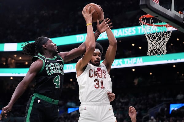 Boston Celtics guard Jrue Holiday (4) battles for a rebound against Cleveland Cavaliers center Jarrett Allen (31) during the first half of an Emirates NBA Cup basketball game, Tuesday, Nov. 19, 2024, in Boston. (AP Photo/Charles Krupa)