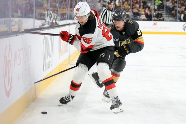 New Jersey Devils center Jack Hughes (86) and Vegas Golden Knights center Jack Eichel (9) battle for the puck during the first period of an NHL hockey game Sunday, March 2, 2025, in Las Vegas. (AP Photo/Ian Maule)