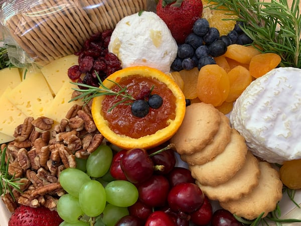 This cheese board includes two cow’s milk cheeses — Concord tomme and WayPoint — along with a crottin of fresh pear and cardamom chevre. Courtesy of CalyRoad 