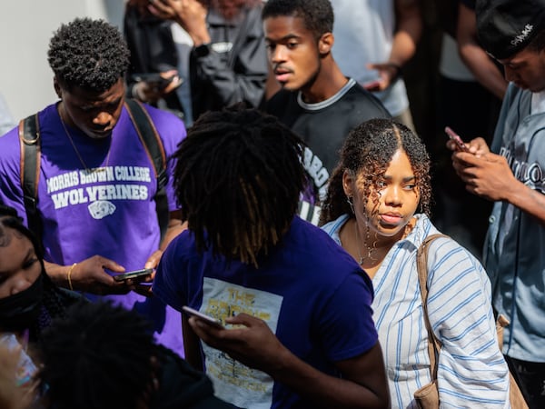 Faith Shamley (right) waits to receive a tablet at Morris Brown on Monday, August 15, 2022. (Arvin Temkar / arvin.temkar@ajc.com)