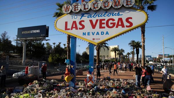 Flowers, candles and other items surround the famous Las Vegas sign at a makeshift memorial for victims of a mass shooting Monday, Oct. 9, 2017, in Las Vegas. Stephen Paddock opened fire on an outdoor country music concert killing dozens and injuring hundreds. (AP Photo/John Locher)