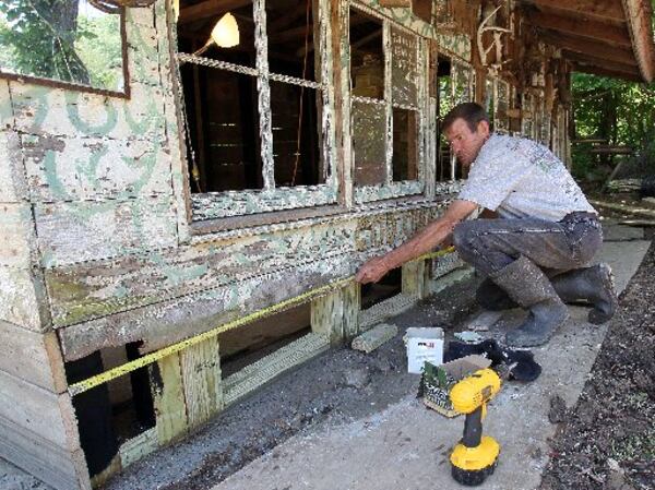 Carpenter Michael Sanders helped restore the "Rabbit Hutch" at famed folk artist Howard Finster's Paradise Garden in Summerville in summer 2013. A lot of work has been done in stabilizing of the elevated Rolling Chair Ramp, restoration of mosaic walkways and interior work on the World's Folk Art Chapel. PHIL SKINNER / PSKINNER@AJC.COM