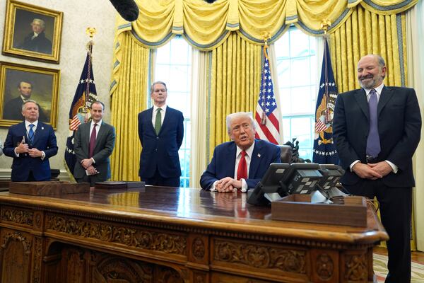 President Donald Trump speaks as Steve Witkoff, special envoy for the Middle East, from left, White House staff secretary Will Scharf, Treasury Secretary Scott Bessent and Commerce Secretary Howard Lutnick listen, as Trump signs executive orders in the Oval Office of the White House, Monday, Feb. 3, 2025, in Washington. (AP Photo/Evan Vucci)