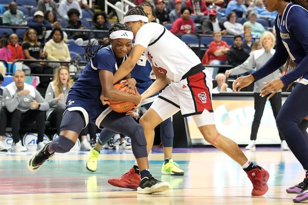 North Carolina State guard Zoe Brooks, right, and Georgia Tech guard Chazadi Wright, left, fight for a rebound during an NCAA college basketball game in the quarterfinals of the Atlantic Coast Conference tournament Greensboro, N.C., Friday, March 7, 2025. (AP Photo/Chuck Burton)