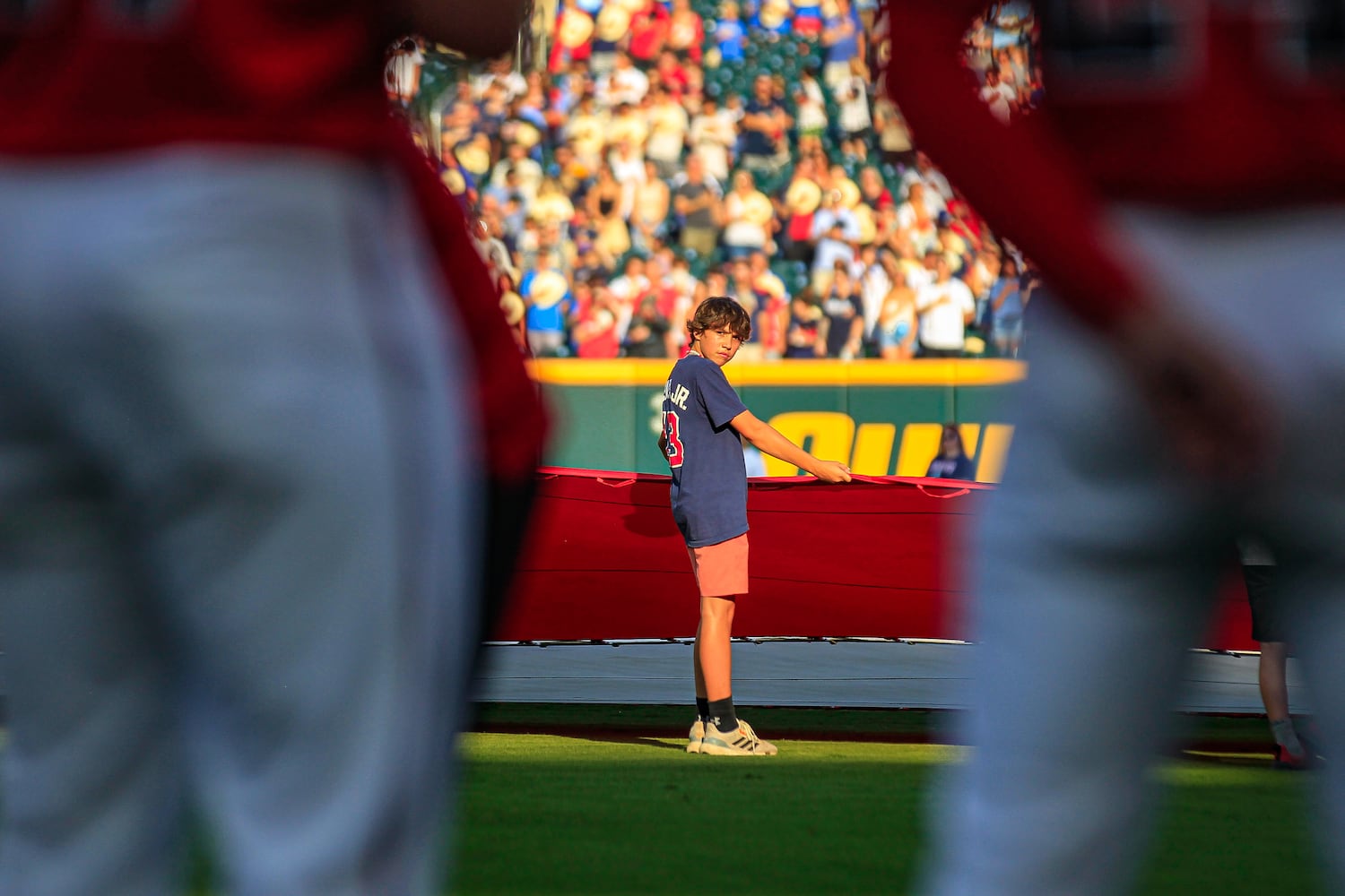 A volunteer participates in holding the giant U.S. flag to commemorate Flag Day and Army Birthday before the game against the Tampa Bay Rays at Truist Park in Atlanta, Georgia  on Friday, June 14, 2024.   (Ziyu Julian Zhu / AJC)