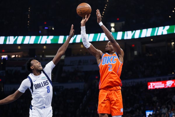 Oklahoma City Thunder guard Shai Gilgeous-Alexander (2) shoots a 3-pointer over Dallas Mavericks forward Olivier-Maxence Prosper (8) during the first half of an Emirates NBA Cup basketball game, Tuesday, Dec. 3, 2024, in Oklahoma City. (AP Photo/Nate Billings)