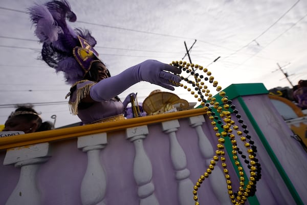 Beads are thrown during the Zulu parade on Mardi Gras Day, Tuesday, March 4, 2025 in New Orleans. (AP Photo/Gerald Herbert)