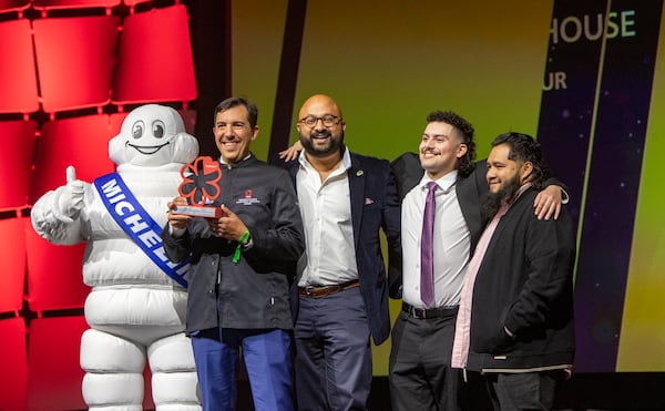 The Michelin Guide Awards take place at the Georgia World Congress Center on Monday, Oct 28, 2024, where Miles Macquarrie (second from left) of Kimball House is awarded the Exceptional Cocktails Award. (Jenni Girtman for the AJC)