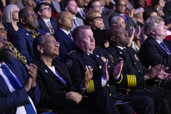 Atlanta Police Chief Darin Schierbaum along with Atlanta Fire Rescue Chief Rodney Smith clap during a video featuring the city’s new public safety training center before Mayor Andre Dickens gives the final State of the City address of his first term at Woodruff Arts Center in Atlanta on Tuesday, February 25, 2025. (Arvin Temkar / AJC)