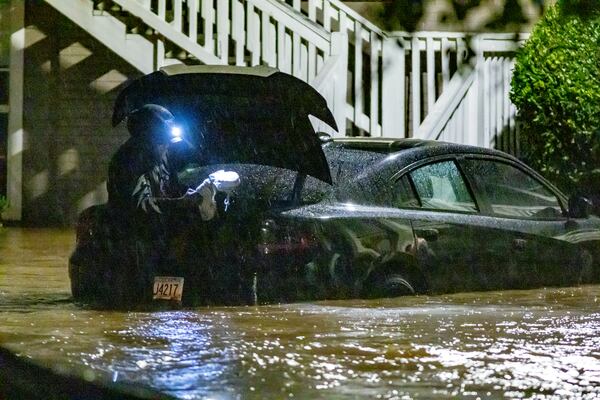 Flood waters at Peachtree Park apartments partially submerged cars on Friday, Sept. 27, 2024. Helene, which entered Georgia as a Category 2 hurricane Friday morning, downgraded to a tropical storm but brought a lot of problems to Atlanta with numerous water rescues and incessant rain. More than 1.1 million power outages have been reported statewide, and flash flooding remained a major concern. (John Spink/AJC)