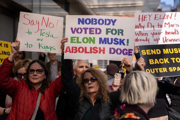 Demonstrators take part in a protest against Elon Musk and Tesla outside of a Tesla showroom, Saturday, March 01, 2025 in New York. (AP Photo/Adam Gray)