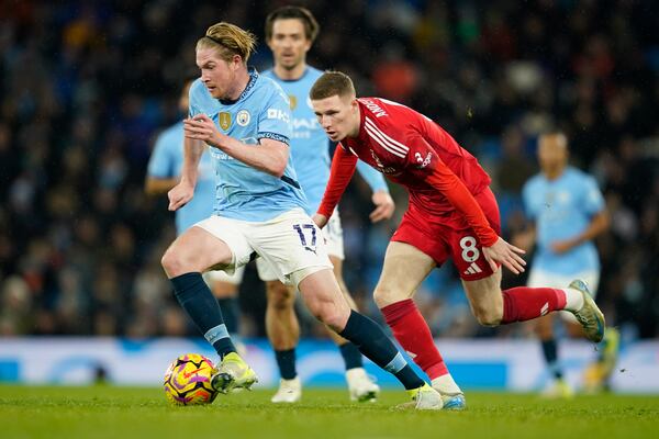 Manchester City's Kevin De Bruyne, left, and Nottingham Forest's Elliot Anderson challenge for the ball during the English Premier League soccer match between Manchester City and Nottingham Forest at the Etihad Stadium in Manchester, Wednesday, Dec. 4, 2024. (AP Photo/Dave Thompson)