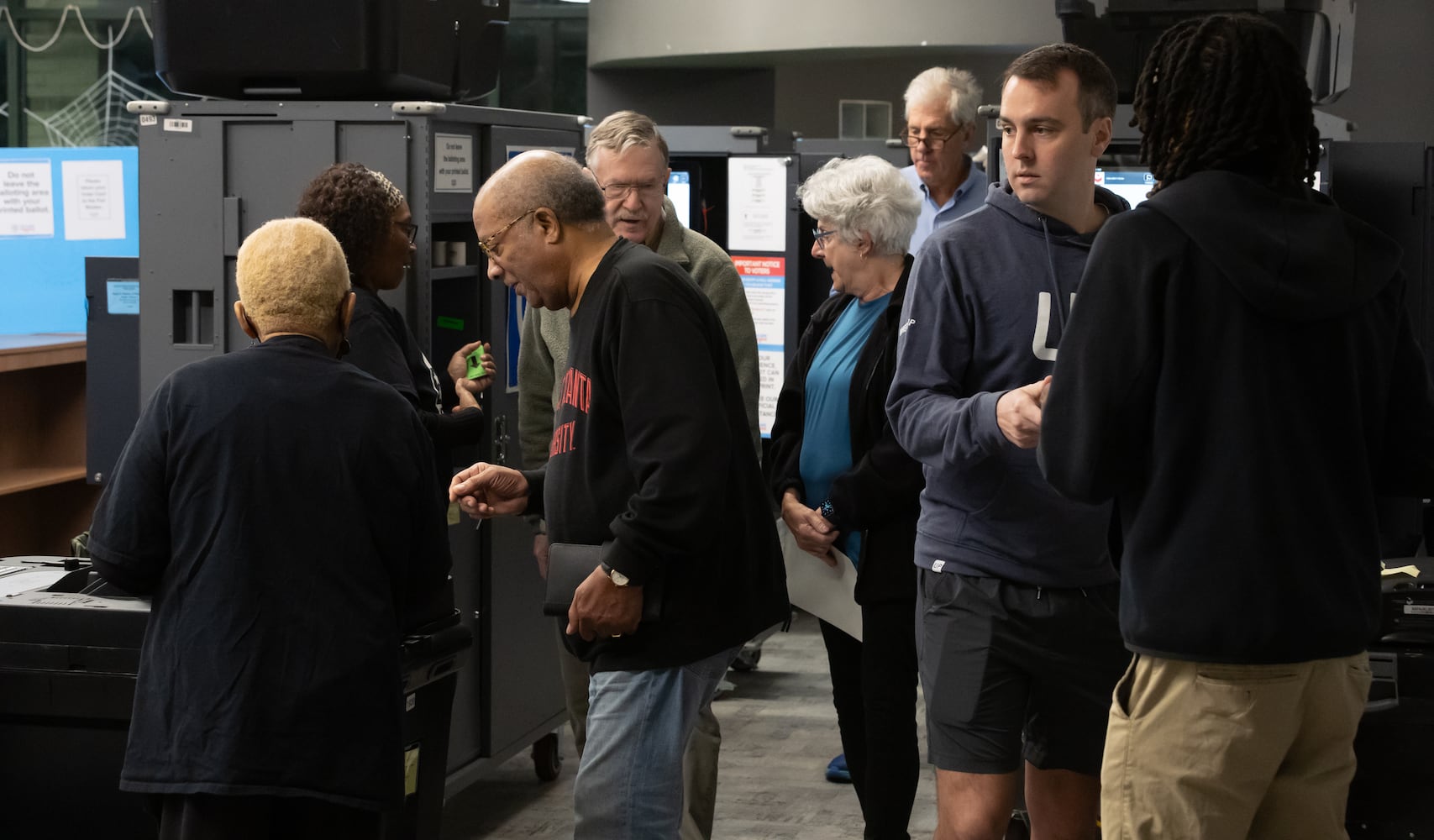 Voters prepare to turn in ballots at the Joan P. Garner Library located at 980 Ponce De Leon Ave N in Atlanta on Tuesday, Oct. 15, 2024. Polling places opened for the first day of early voting Tuesday as Georgia prepares for another tour as one of America’s most hotly contested states. The state’s 8.2 million registered voters will consider important races up and down the ballot. (John Spink/AJC)