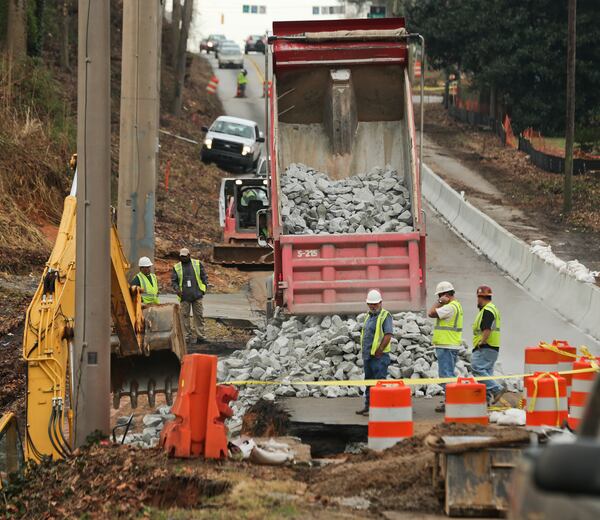 Georgia Department of Transportation contractors were on Northside Drive where traffic was shut down both ways between Spring Valley Drive and Echota Drive. JOHN SPINK/JSPINK@AJC.COM