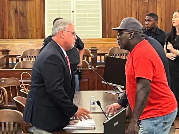 Sapelo Island descendant Maurice Bailey talks with McIntosh County Commission Chairman David Stevens following the County Commission meeting on Tuesday in Darien. Stevens was one of three commissioners who voted for a new law that will allow larger homes to be built on the island, which descendants of Sapelo's Gullah Geechee community fear could destroy their culture. (Richard Burkhart/Savannah Morning News via AP)