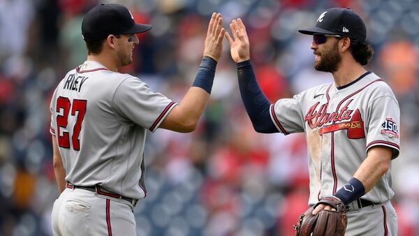 Braves teammates Austin Riley (27) and Dansby Swanson (right) celebrate 6-5 win over the Washington Nationals, Sunday, Aug. 15, 2021, in Washington. (Nick Wass/AP)