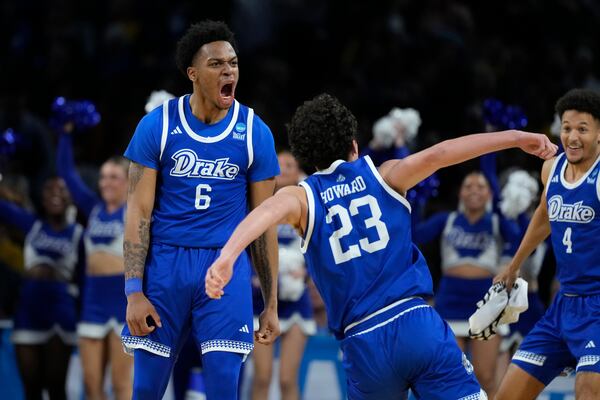 Drake guard Tavion Banks (6) and Drake guard Isaia Howard (23) celebrates after Banks made a basket during the second half of a game against Missouri in the first round of the NCAA college basketball tournament, Thursday, March 20, 2025, in Wichita, Kan. (AP Photo/Charlie Riedel)