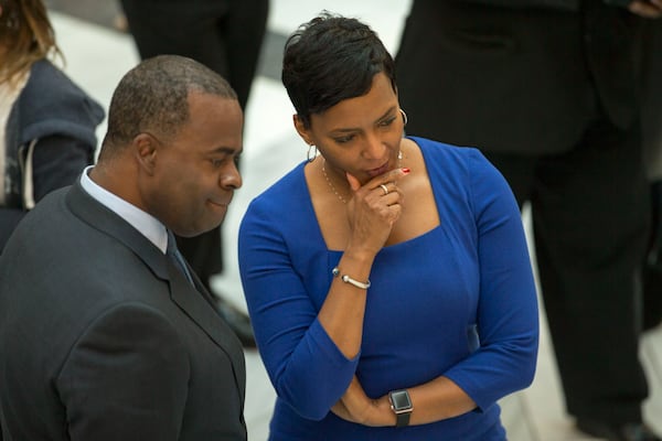 12/29/2017 -- Atlanta, GA, - Atlanta mayor Kasim Reed and mayor elect Keisha Lance-Bottoms talk amongst themselves during the Reed's final workday at Atlanta City Hall, Friday, December 29, 2017. In addition to unveiling last minute decisions that he oversaw during his time as mayor of Atlanta, Kasim Reed also celebrated with food and a live dj in the auditorium of the building.  ALYSSA POINTER/ALYSSA.POINTER@AJC.COM