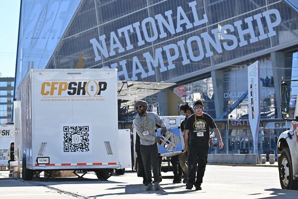 Crew prepares to set up a structural beam at Georgia International Plaza ahead of College Football National Championship between Notre Dame and Ohio State, Friday, January 17, 2025, in Atlanta. (Hyosub Shin / AJC)