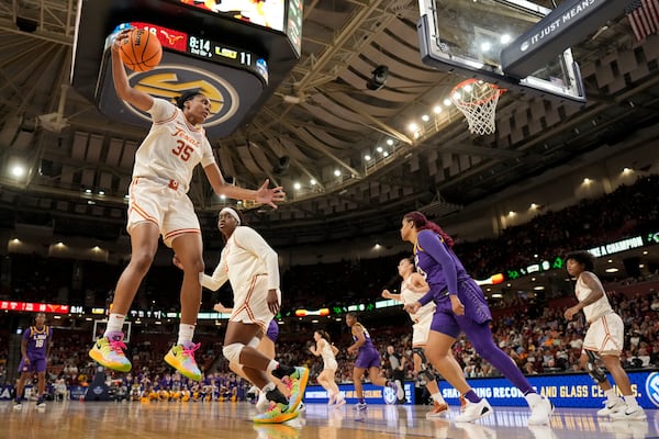 Texas forward Madison Booker grabs a rebound against LSU during the first half during of an NCAA college basketball game in the semifinals of the Southeastern Conference tournament, Saturday, March 8, 2025, in Greenville, S.C. (AP Photo/Chris Carlson)