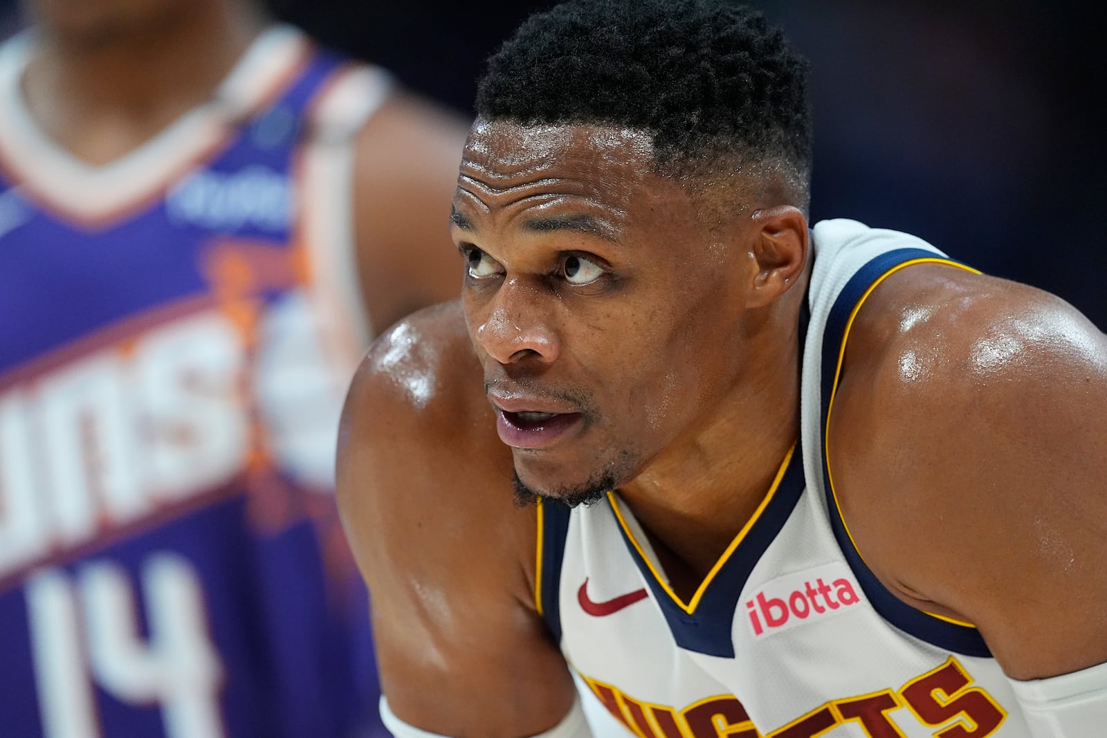 Denver Nuggets guard Russell Westbrook waits for play to resume in the second half of an NBA preseason game against the Phoenix Suns, Sunday, Oct. 13, 2024, in Denver. (AP Photo/David Zalubowski)