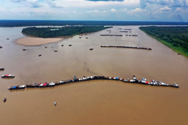 FILE - Dredging barges operated by illegal miners converge on the Madeira river, a tributary of the Amazon river, searching for gold, in Autazes, Amazonas state, Brazil, Nov. 25, 2021. (AP Photo/Edmar Barros, File)