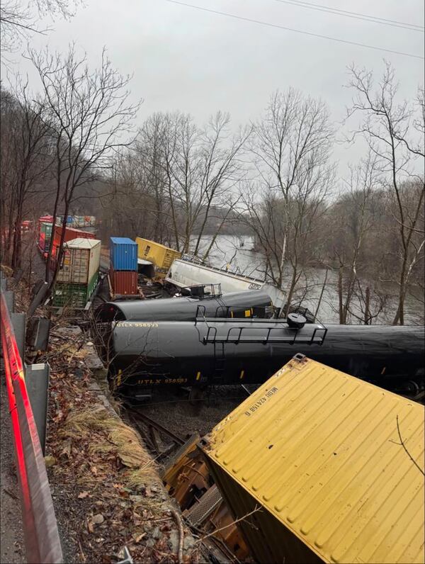 This photo provided by Nancy Run Fire Company shows a train derailment along a riverbank in Saucon Township, Pa., on Saturday, March 2, 2024.   Authorities said it was unclear how many cars were involved but no injuries or hazardous materials were reported.   (Nancy Run Fire Company via AP)