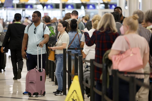 Passengers go through the main security checkpoint for departures at the domestic terminal at Hartsfield-Jackson International Airport on Wednesday. Equipment upgrades at the checkpoint are included in the airport's master plan. (Jason Getz / Jason.Getz@ajc.com)