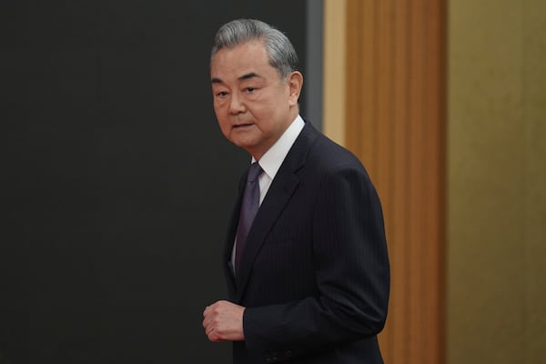 Chinese Foreign Minister Wang Yi arrives for a press conference on the sideline of the National People's Congress in Beijing, Friday, March 7, 2025. (AP Photo/Ng Han Guan)