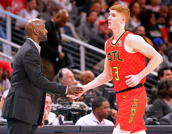 Hawks guard Kevin Huerter gets five from coach Lloyd Pierce during game against the Miami Heat Sunday,  Jan. 6, 2019, at State Farm Arena in Atlanta. (Curtis Compton/ccompton@ajc.com)