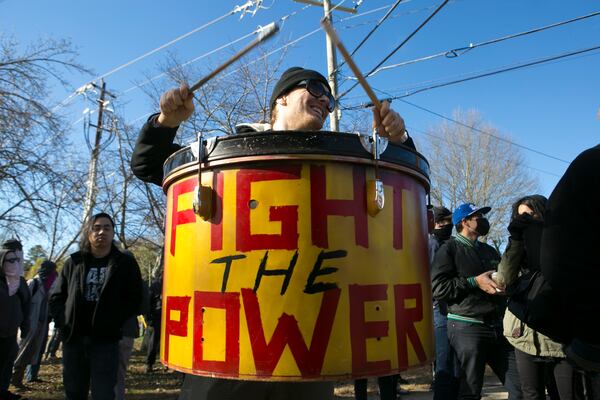 A counterprotester bangs a drum that reads "FIGHT THE POWER" outside of the Stone Mountain Village Visitor Center on Saturday, Feb. 2, 2019. Although a planned white nationalist rally at Stone Mountain Park was canceled by its organizers and the park was closed, more than 100 counterprotesters gathered to march outside the park in the nearby town. (Photo: Casey Sykes for The Atlanta Journal-Constitution)