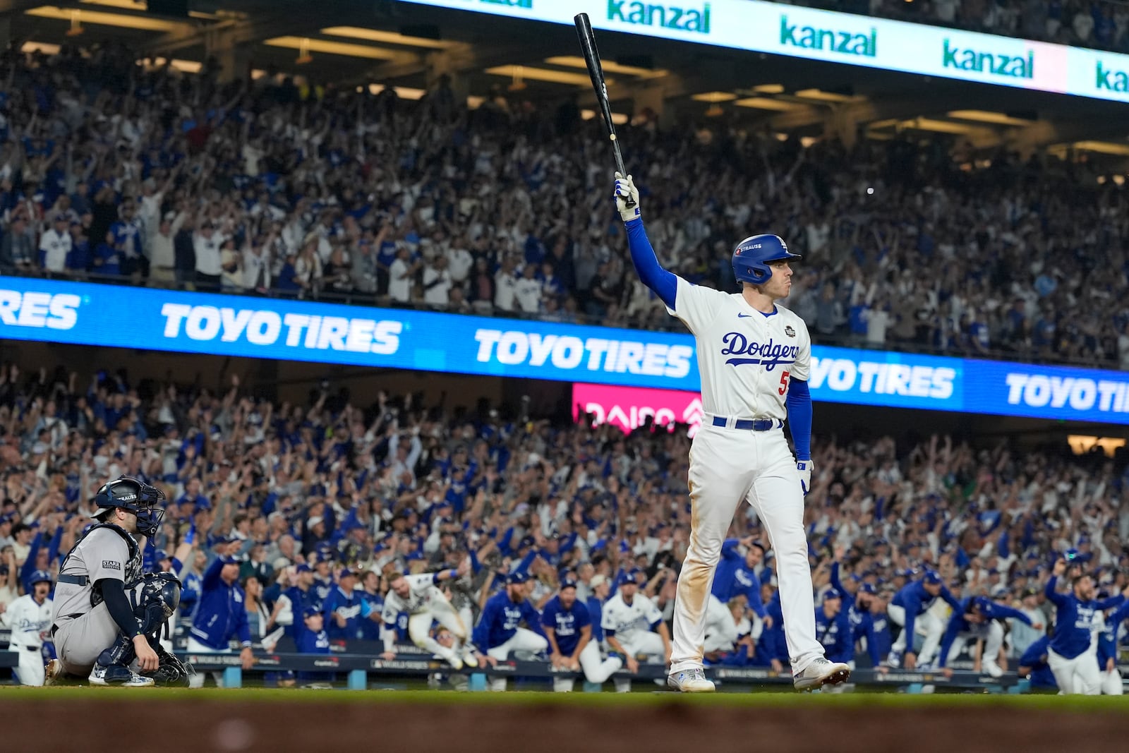 Los Angeles Dodgers' Freddie Freeman celebrates his walk-off grand slam home run against the New York Yankees during the 10th inning in Game 1 of the baseball World Series, Friday, Oct. 25, 2024, in Los Angeles. (AP Photo/Ashley Landis)