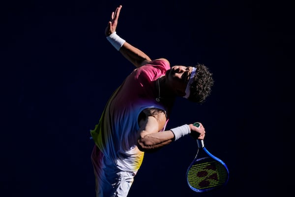 Ben Shelton of the U.S. serves to Lorenzo Sonego of Italy during their quarterfinal match at the Australian Open tennis championship in Melbourne, Australia, Wednesday, Jan. 22, 2025. (AP Photo/Vincent Thian)