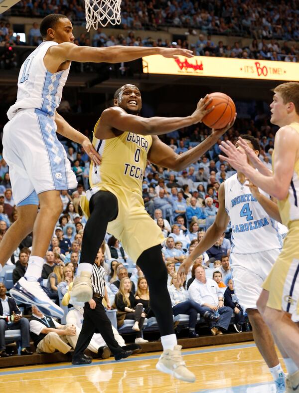 Gerogia Tech's Charles Mitchell (0) is stopped short of the basket by North Carolina's Brice Johnson (left) as North Carolina's Isaiah Hicks (4) and Georgia Tech's Ben Lammers, right, look on during the second half of an NCAA basketball game, Saturday, Jan. 2, 2016, in Chapel Hill, N.C. North Carolina won 86-78. (AP Photo/Ellen Ozier)