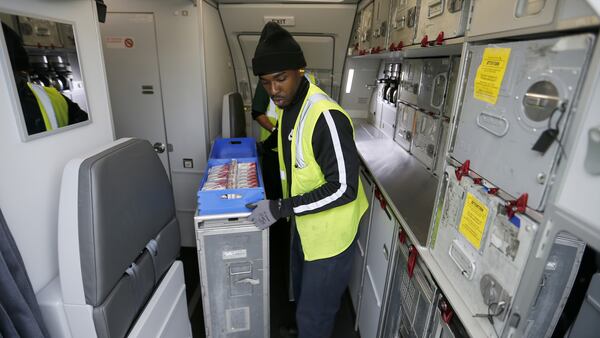 A food service worker loads food aboard American Airlines Flight 2381 to Orlando, Fla. at Los Angeles International Airport. (Allen J. Schaben/Los Angeles Times/TNS)