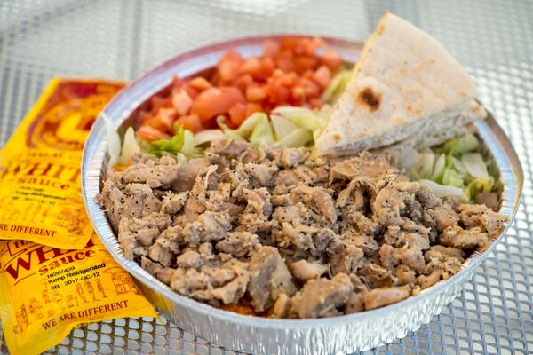  Chicken Platter with rice, lettuce, tomato, and grilled pita. Photo credit- Mia Yakel.