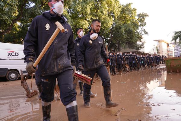 Police officers prepare to work on the clean up operation after flooding in Massanassa on the outskirts of Valencia, Spain, Wednesday, Nov. 6, 2024. (AP Photo/Alberto Saiz)