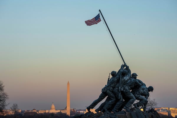 The U.S. Marine Corps Memorial photographed at sunset with the U.S. Capitol and Washington Monument in the background.