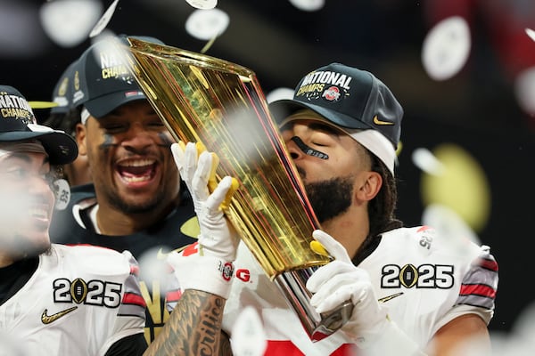 Ohio State tight end Gee Scott Jr. kisses the national championship trophy after their 34-23 win against Notre Dame in the 2025 National Championship at Mercedes-Benz Stadium, Monday, Jan. 20, 2025, in Atlanta. (Jason Getz / AJC)