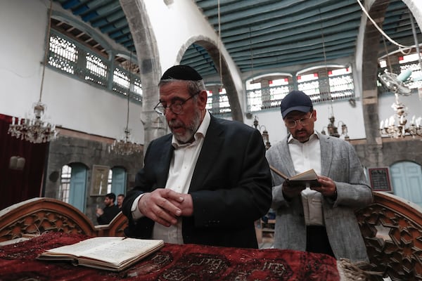 FILE - Rabbi Yusuf Hamra, center left, prays the Al-Raqi synagogue in the old city of Damascus, Feb. 18, 2025. (AP Photo/Omar Sanadiki, File)