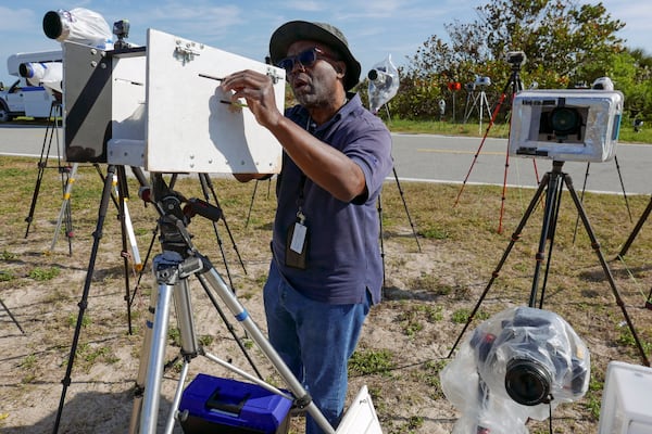 Photographer Craig Bailey resets his remote cameras with fresh batteries to cover this evening's scheduled launch of a SpaceX Falcon 9 rocket with the Crew Dragon spacecraft for a mission to the International Space Station on pad 39A at the Kennedy Space Center in Cape Canaveral, Fla., Friday, March 14, 2025. (AP Photo/John Raoux)