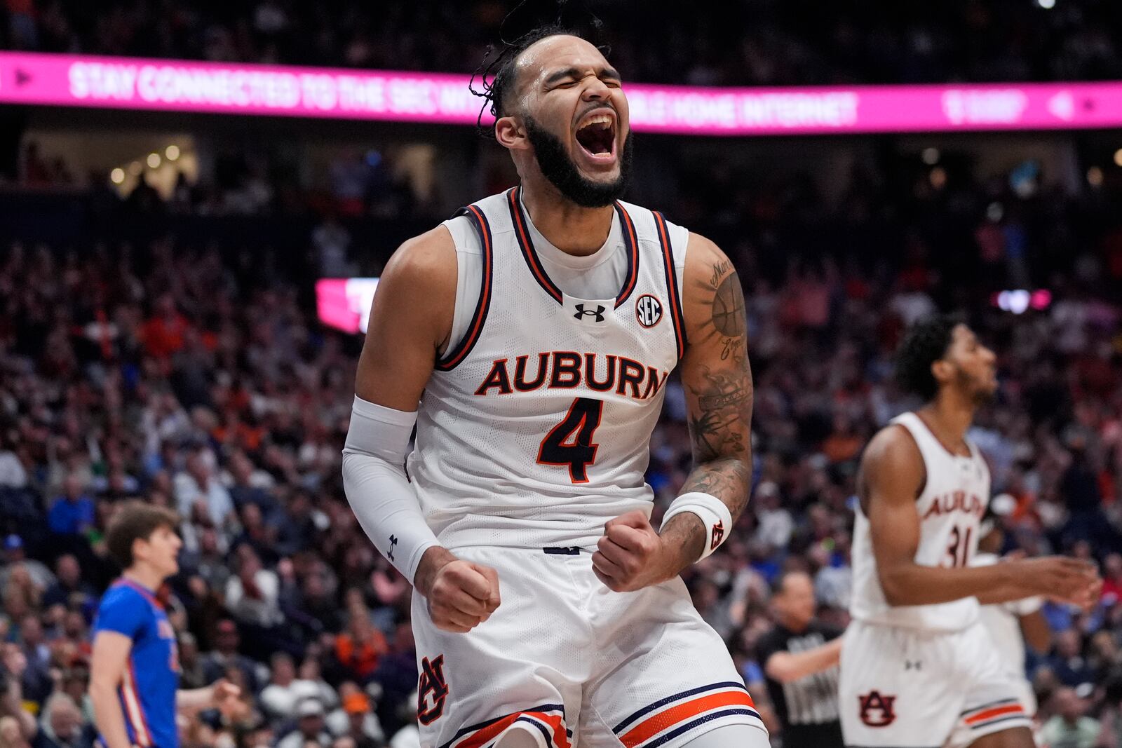 FILE - Auburn forward Johni Broome (4) reacts after a basket during the first half of an NCAA college basketball game against Florida in the finals of the Southeastern Conference tournament Sunday, March 17, 2024, in Nashville, Tenn. (AP Photo/John Bazemore)